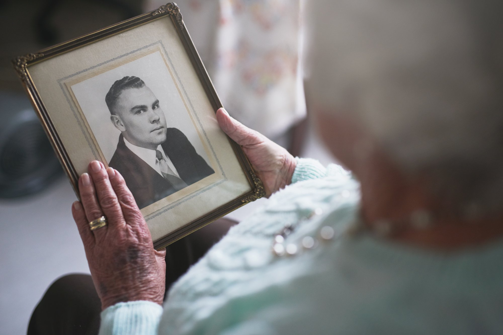 Woman holding and image of a loved one.