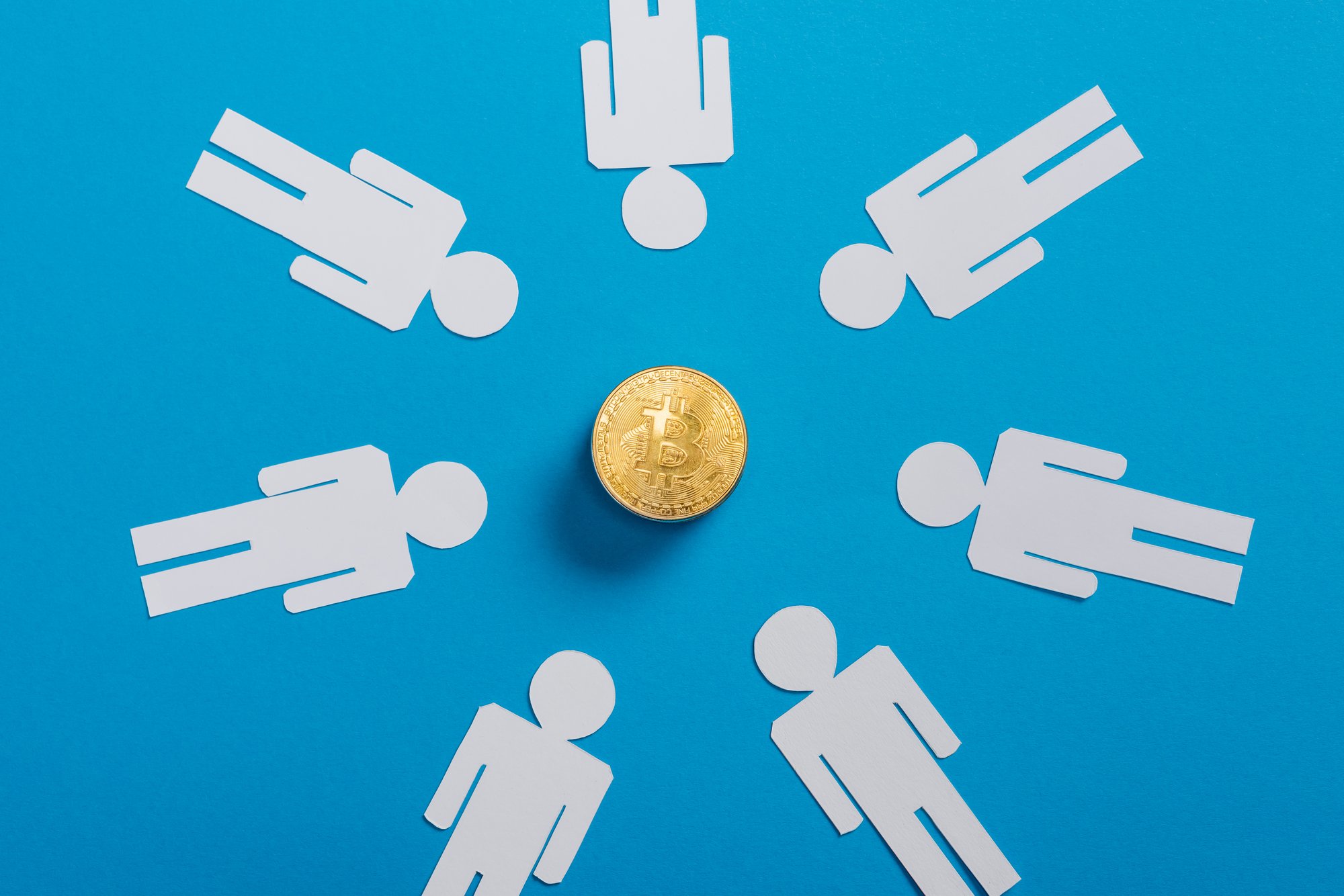 employees circling around a coin